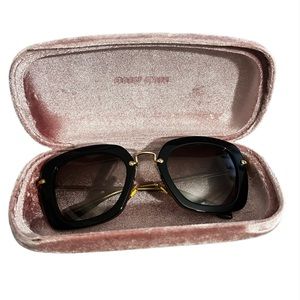 Miu Miu black and gold women’s sunglasses .